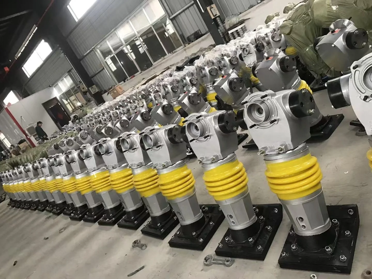 Tamping rammer assemblies, photographed in the workshop.