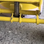 Rear frame and transport-wheel mounting — cropped from the source photograph.