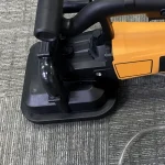 Grinding-head cover and side handle — detail cropped from the source photograph, not another camera angle.