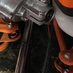 Engine-side assembly and adjacent flexible routing; not a verified coupling drawing — detail cropped from the source photograph, not another camera angle.