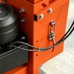 Motor and adjacent hose routing — detail cropped from the source photograph, not another camera angle.