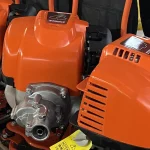 Orange drive housing and engine-side components — detail cropped from the source photograph, not another camera angle.