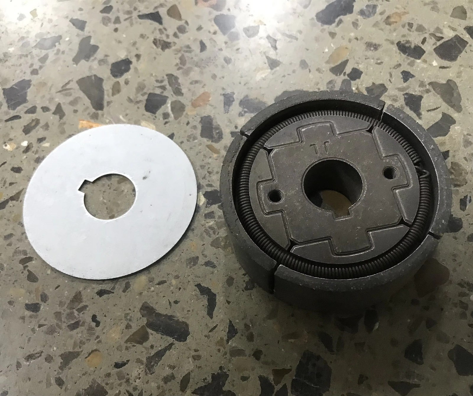 Clutch assembly beside a separate plate